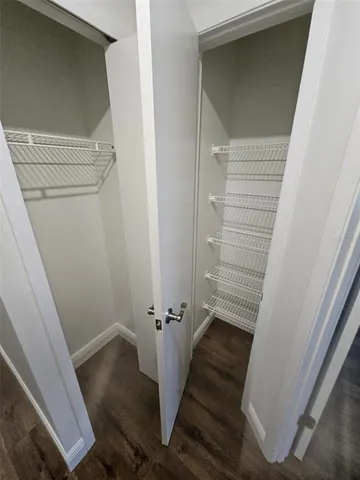 a view of a hallway with wooden floor and entryway