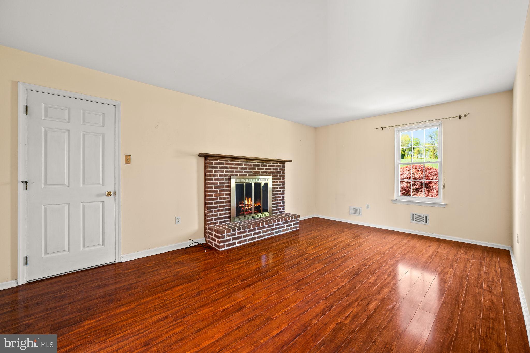1094 Ebelhare Road Pottstown, PA 19465 - Photo 25 of 45 an empty room with wooden floor and windows