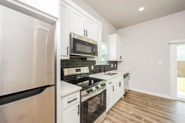 a kitchen with a stove microwave and sink