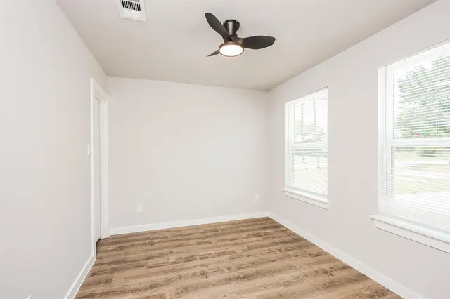 a view of a livingroom with a window and a ceiling fan