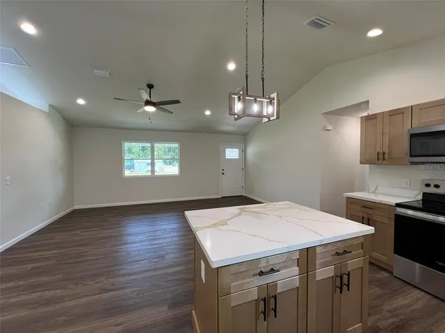 a kitchen that has a lot of cabinets furniture and wooden floor
