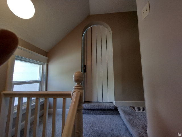 157 West 500 South Logan, UT 84321 - Photo 31 of 38 Carpeted landing with a white wood-finish railing and a window featuring white trim
