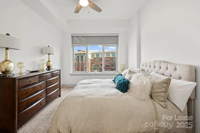 a bedroom with a bed and large window