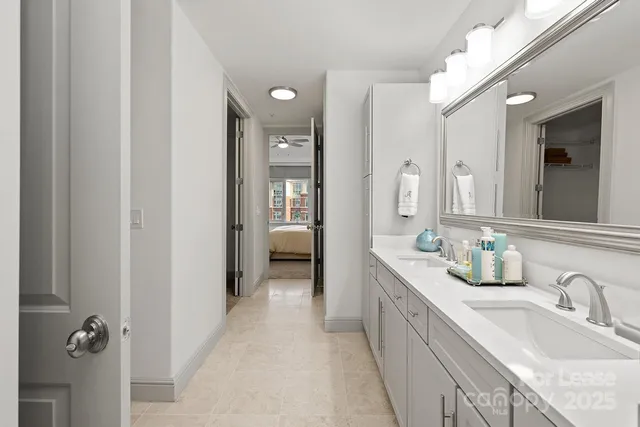 a en suite bathroom with a granite countertop sink mirror and a