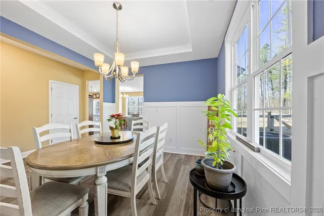 a dining room with furniture and a chandelier