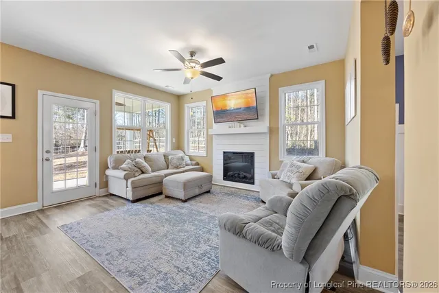 a living room with furniture and a fireplace