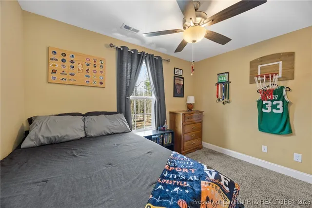 a bedroom with a bed dresser and a window