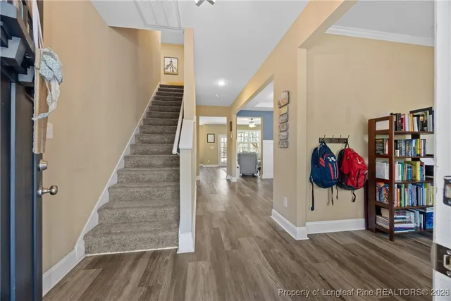 a view of entryway and hall with wooden floor
