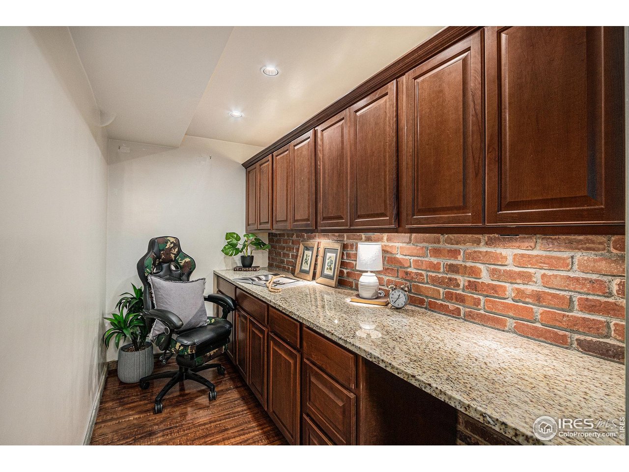 415 South Howes Street North, Unit 202 Fort Collins, CO 80521 - Photo 11 of 21 a kitchen with granite countertop a sink cabinets and wooden floor