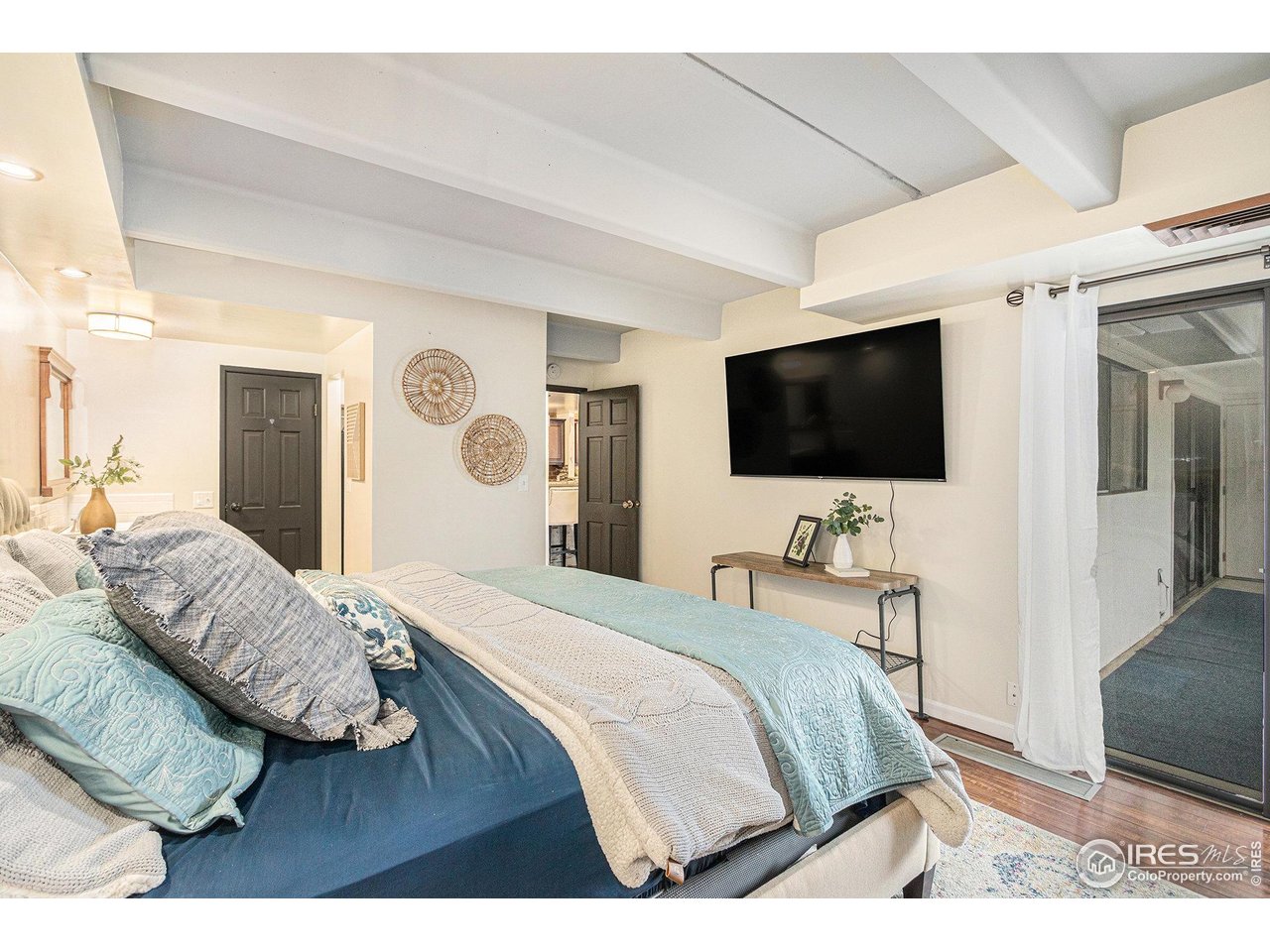 415 South Howes Street North, Unit 202 Fort Collins, CO 80521 - Photo 13 of 21 a bedroom with a bed and a flat screen tv