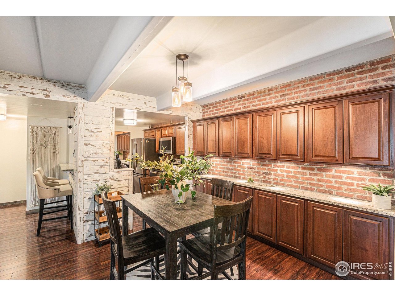 415 South Howes Street North, Unit 202 Fort Collins, CO 80521 - Photo 6 of 21 a kitchen with a dining table chairs and white cabinets