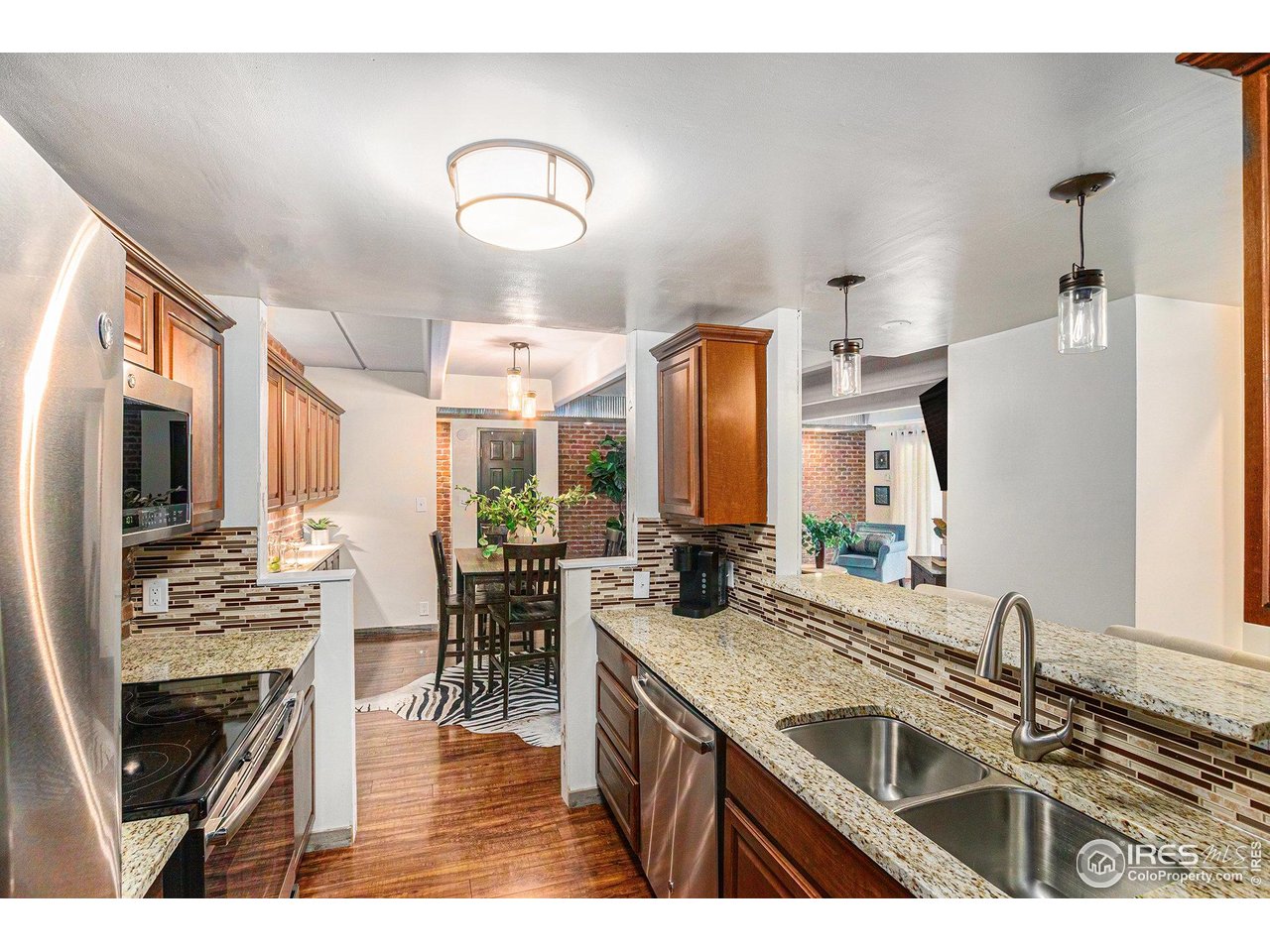 415 South Howes Street North, Unit 202 Fort Collins, CO 80521 - Photo 8 of 21 a kitchen with sink refrigerator and stove