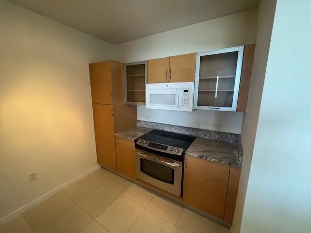a kitchen with a stove and a refrigerator