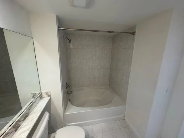 a bathroom with a shower and a toilet
