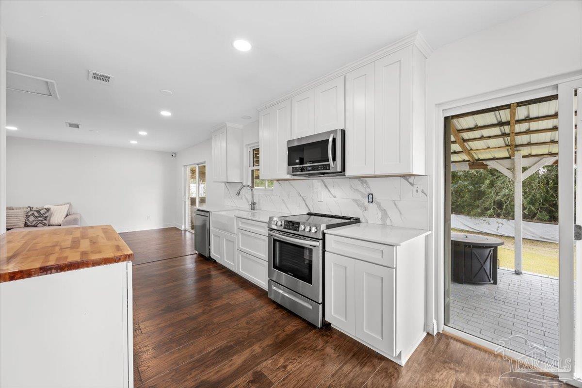 2521 Tomlinson Road Pensacola, FL 32526 - Photo 12 of 30 a kitchen with stainless steel appliances granite countertop a stove a sink and a microwave