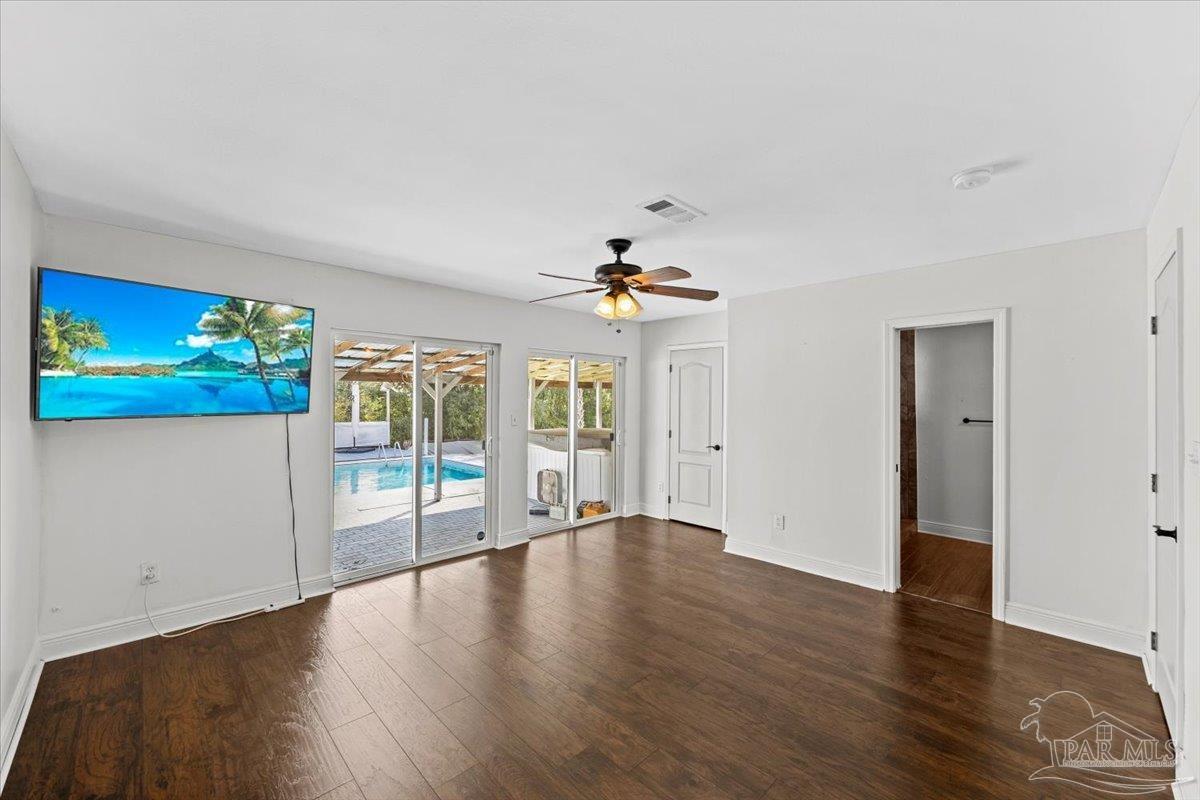 2521 Tomlinson Road Pensacola, FL 32526 - Photo 15 of 30 a view of an empty room with wooden floor and a window