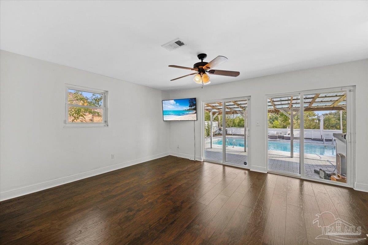 2521 Tomlinson Road Pensacola, FL 32526 - Photo 16 of 30 a view of an empty room with a window and wooden floor