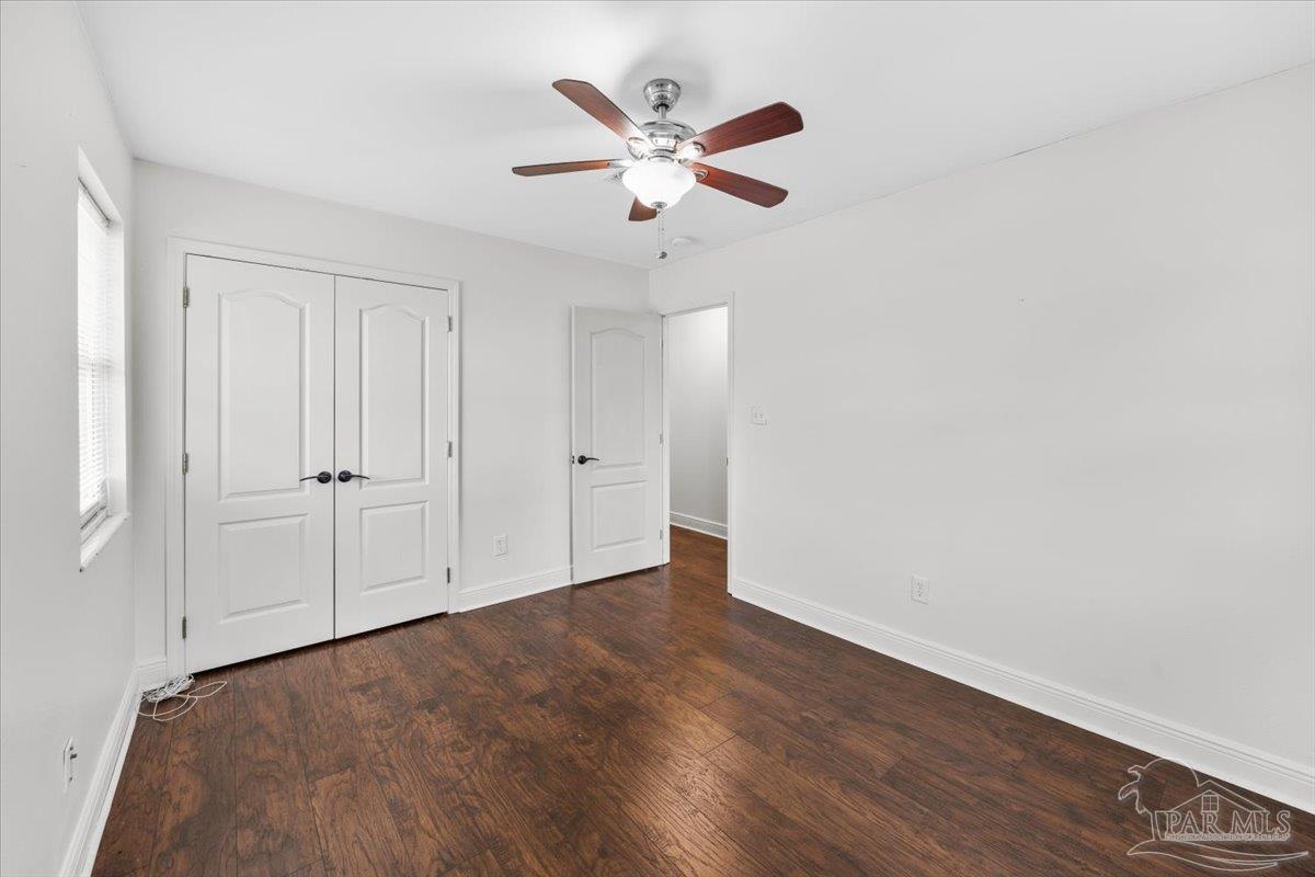 2521 Tomlinson Road Pensacola, FL 32526 - Photo 21 of 30 an empty room with wooden floor and ceiling fan