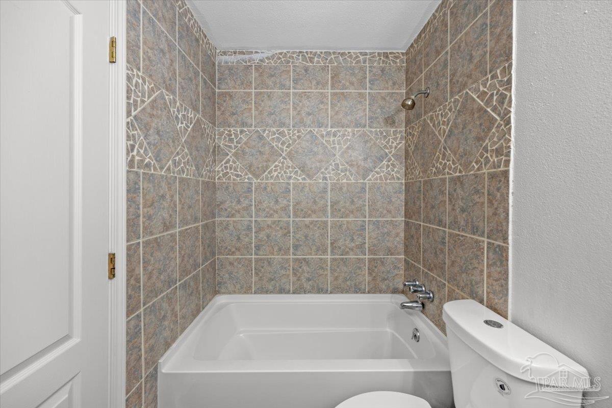 2521 Tomlinson Road Pensacola, FL 32526 - Photo 25 of 30 a bathroom with a bathtub toilet and shower