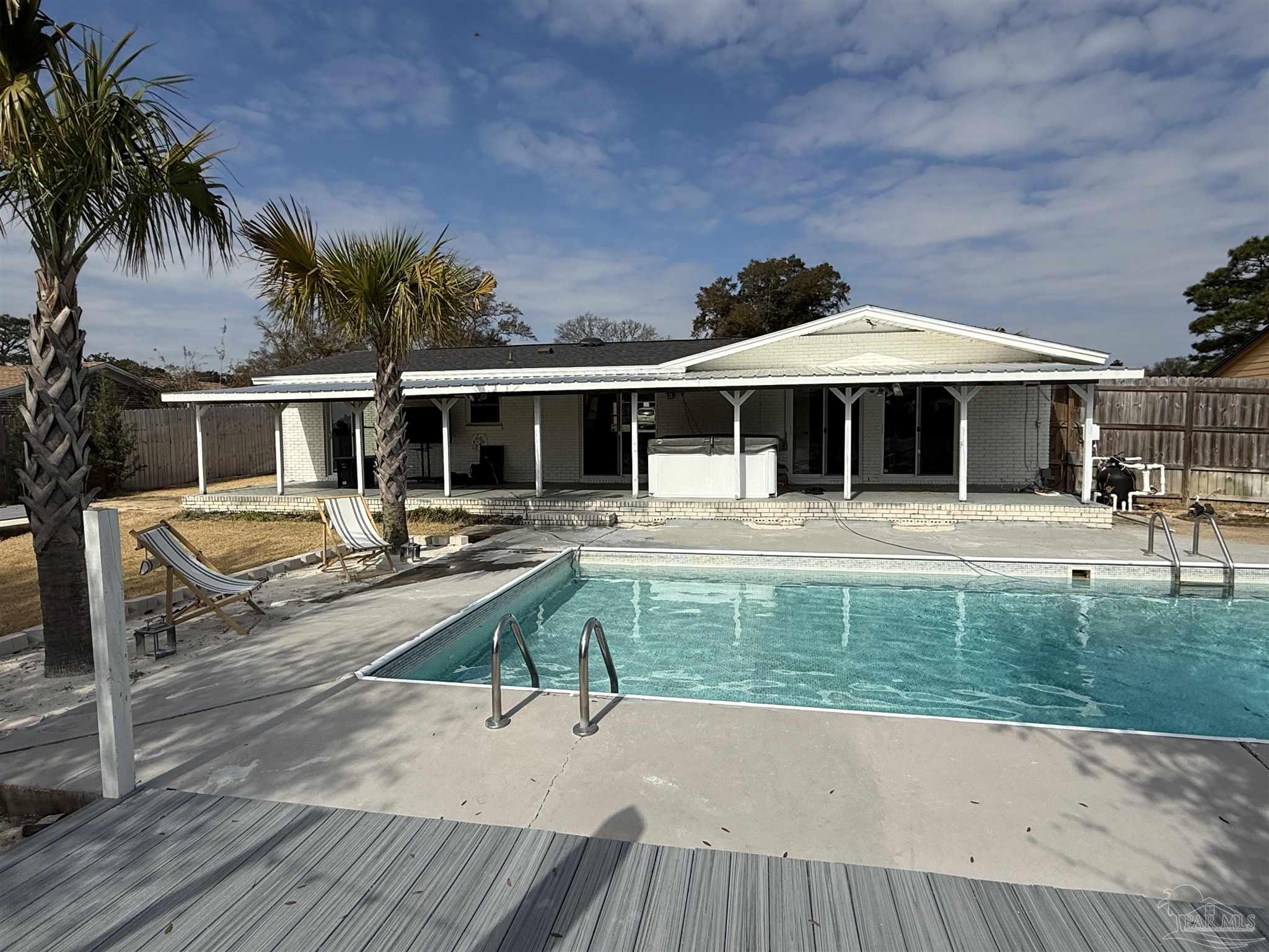 2521 Tomlinson Road Pensacola, FL 32526 - Photo 26 of 30 a view of a house with sitting area and swimming pool