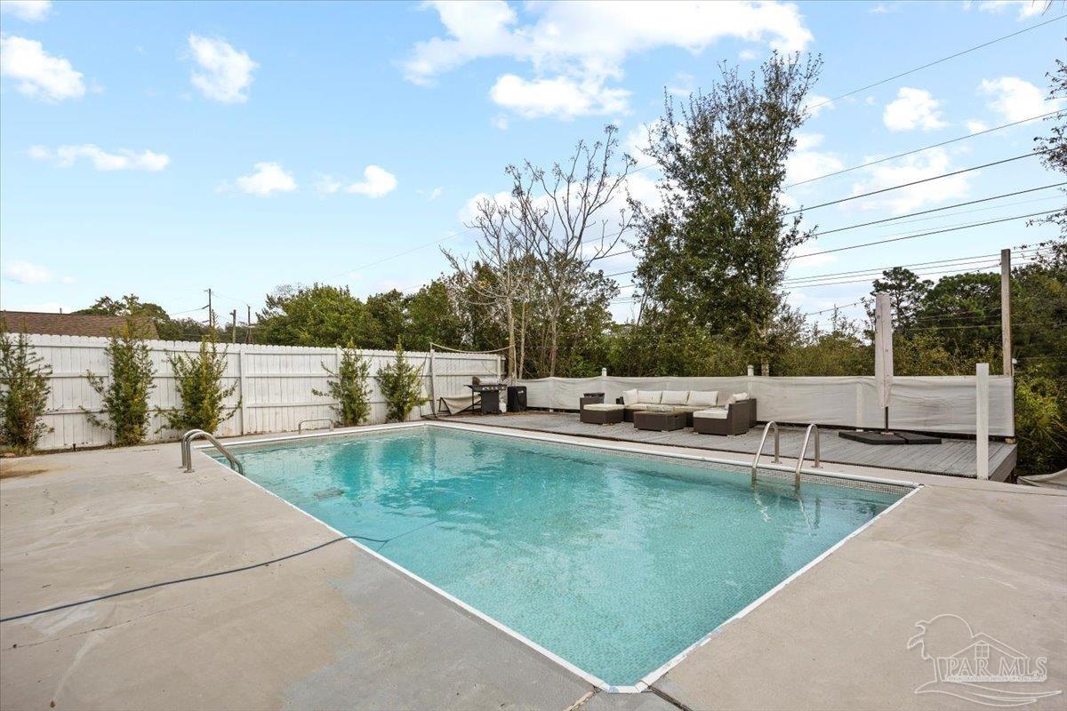2521 Tomlinson Road Pensacola, FL 32526 - Photo 27 of 30 a view of a swimming pool with a lounge chair