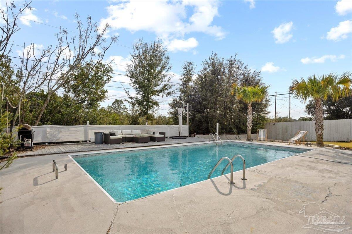 2521 Tomlinson Road Pensacola, FL 32526 - Photo 28 of 30 a view of a swimming pool with a patio and a yard
