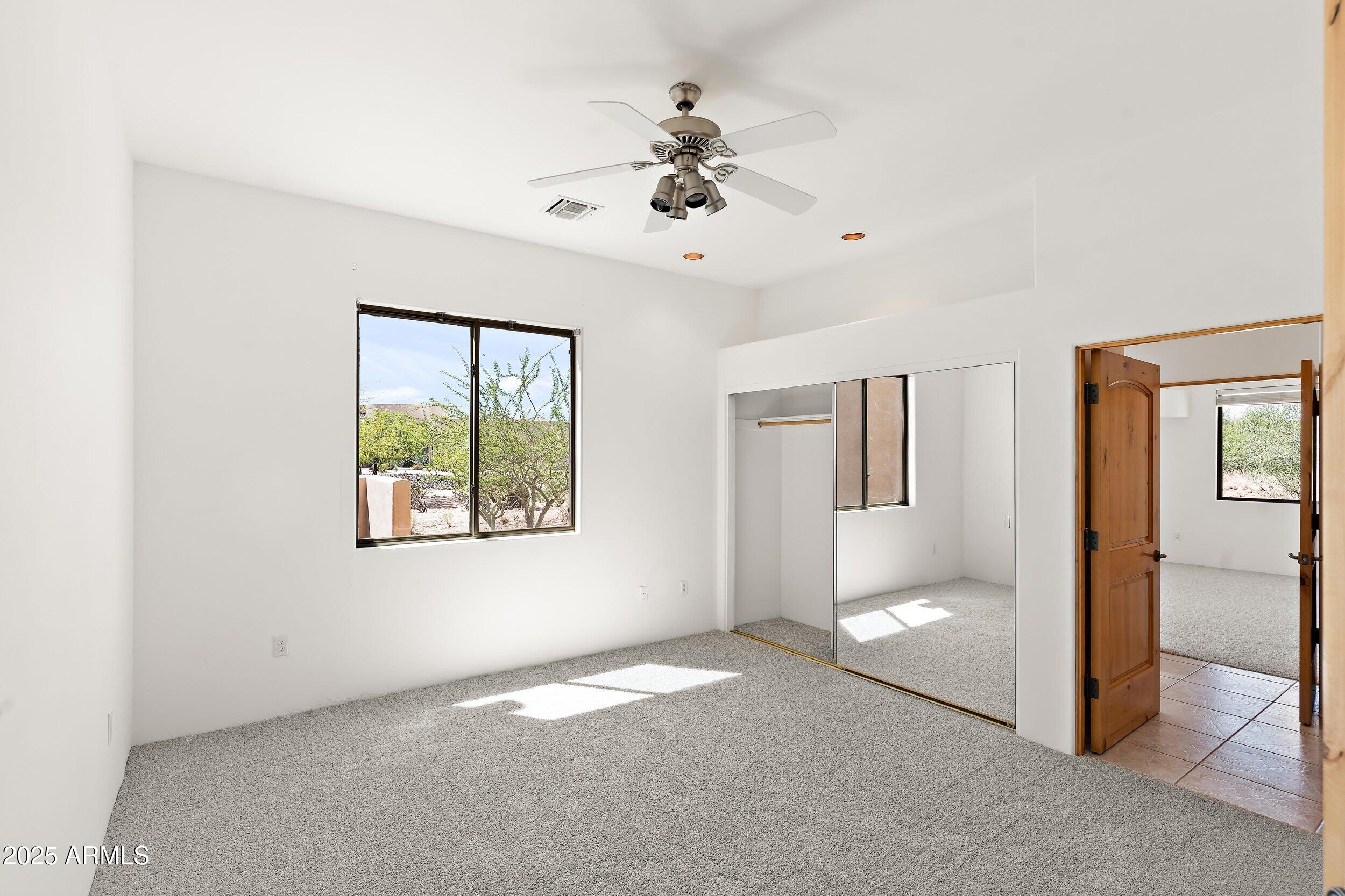 14036 East Ranch Road Scottsdale, AZ 85262 - Photo 12 of 32 a view of livingroom with window ceiling fan and carpet