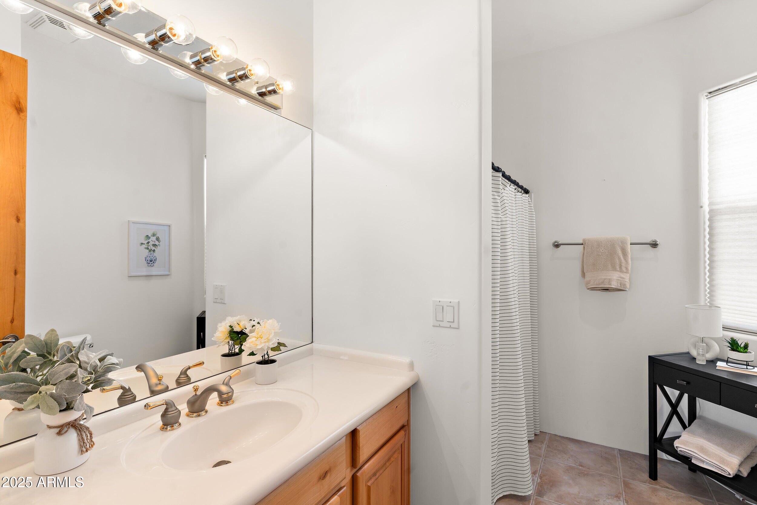 14036 East Ranch Road Scottsdale, AZ 85262 - Photo 16 of 32 a bathroom with a sink and a mirror