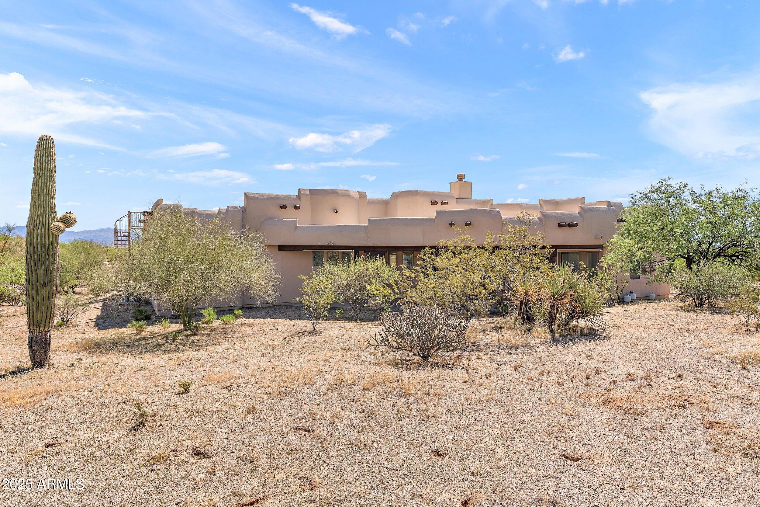 14036 East Ranch Road Scottsdale, AZ 85262 - Photo 26 of 32 a view of a dry yard with a house in the background