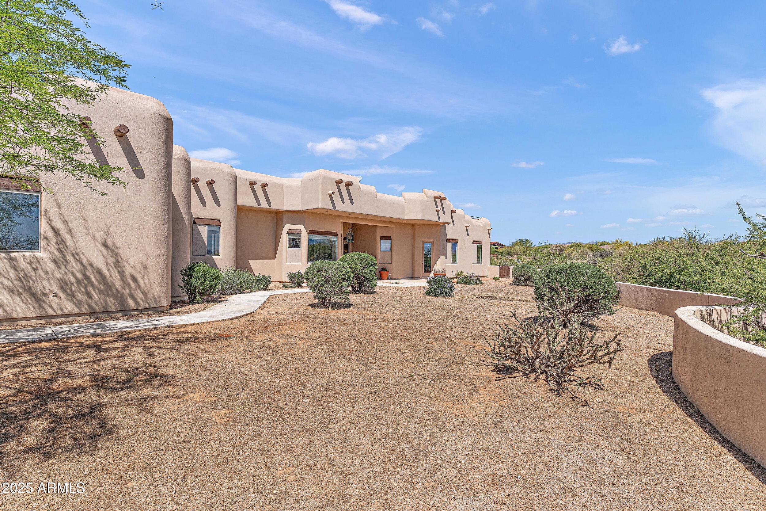 14036 East Ranch Road Scottsdale, AZ 85262 - Photo 28 of 32 a view of a house with a patio