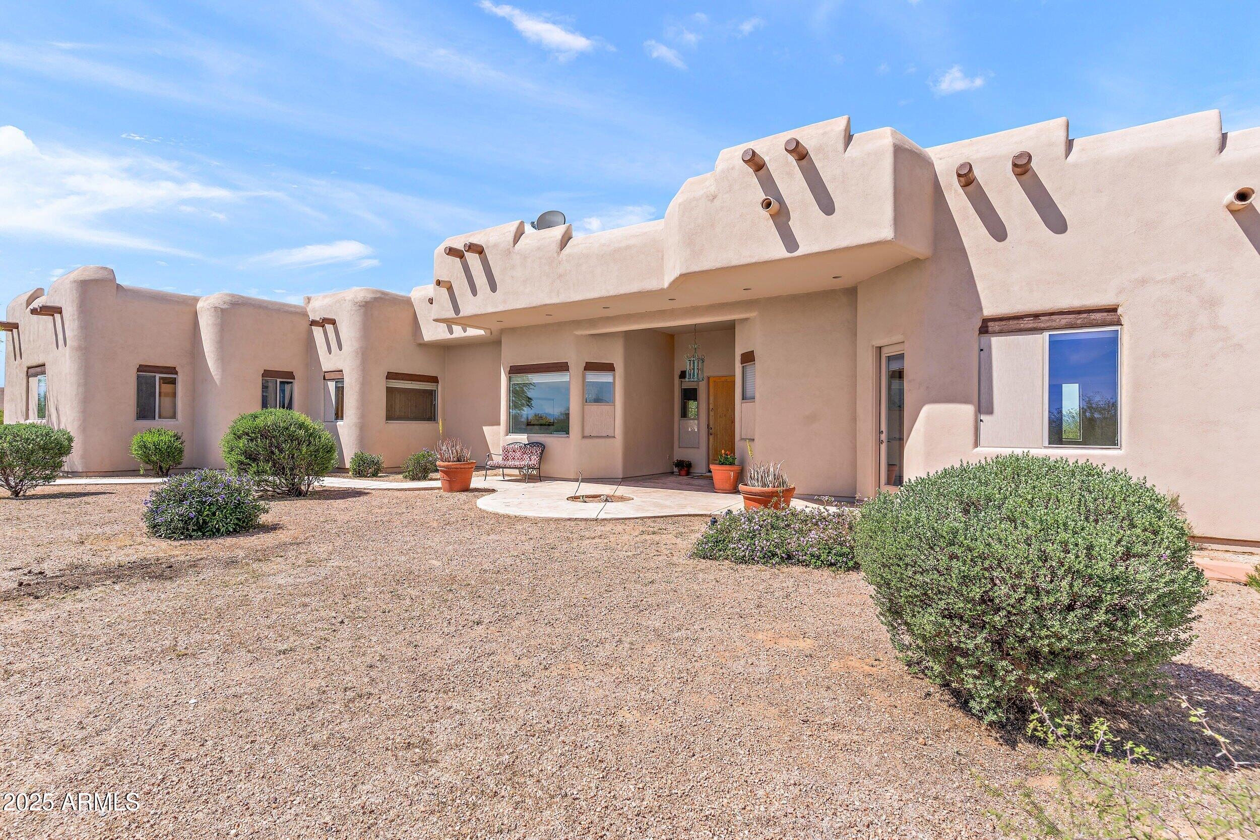 14036 East Ranch Road Scottsdale, AZ 85262 - Photo 29 of 32 a view of a white house with a yard and plants