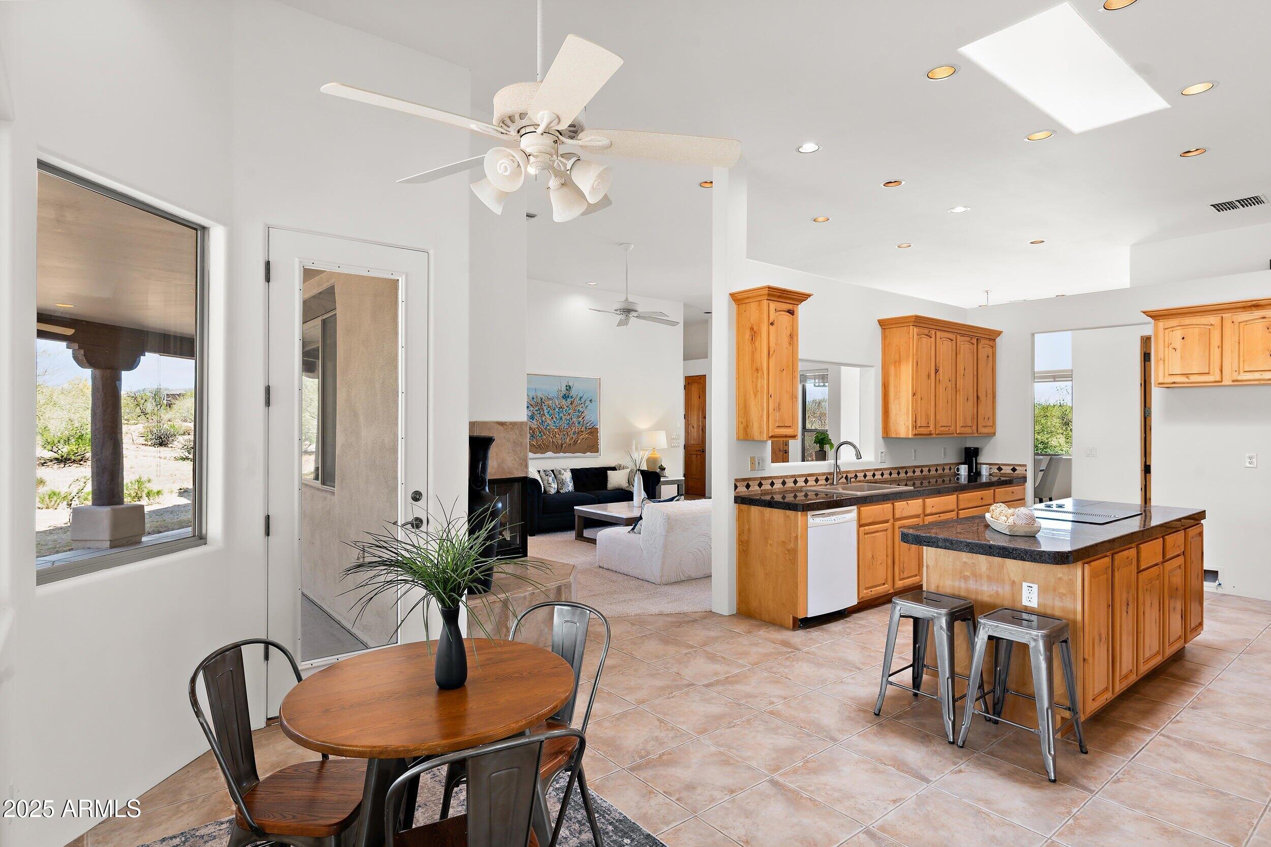 14036 East Ranch Road Scottsdale, AZ 85262 - Photo 9 of 32 a view of a dining room with furniture and a chandelier
