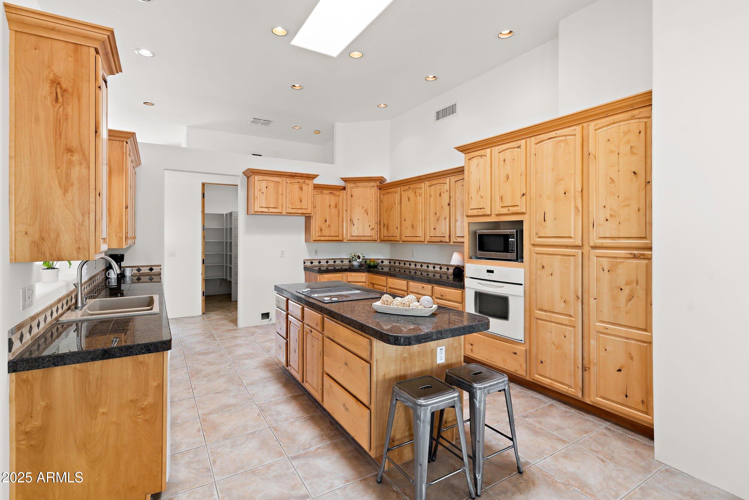 14036 East Ranch Road Scottsdale, AZ 85262 - Photo 10 of 32 a kitchen with a stove a sink and a refrigerator