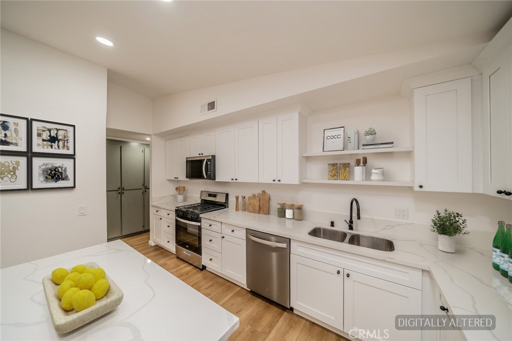 555 North Chestnut Avenue Rialto, CA 92376 - Photo 15 of 33 a kitchen with a sink a stove and cabinets