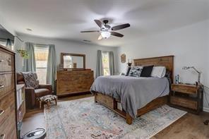 170 Greenbrier Way Canton, GA 30114 - Photo 18 of 34 a bedroom with a bed a couches and dresser with wooden floor