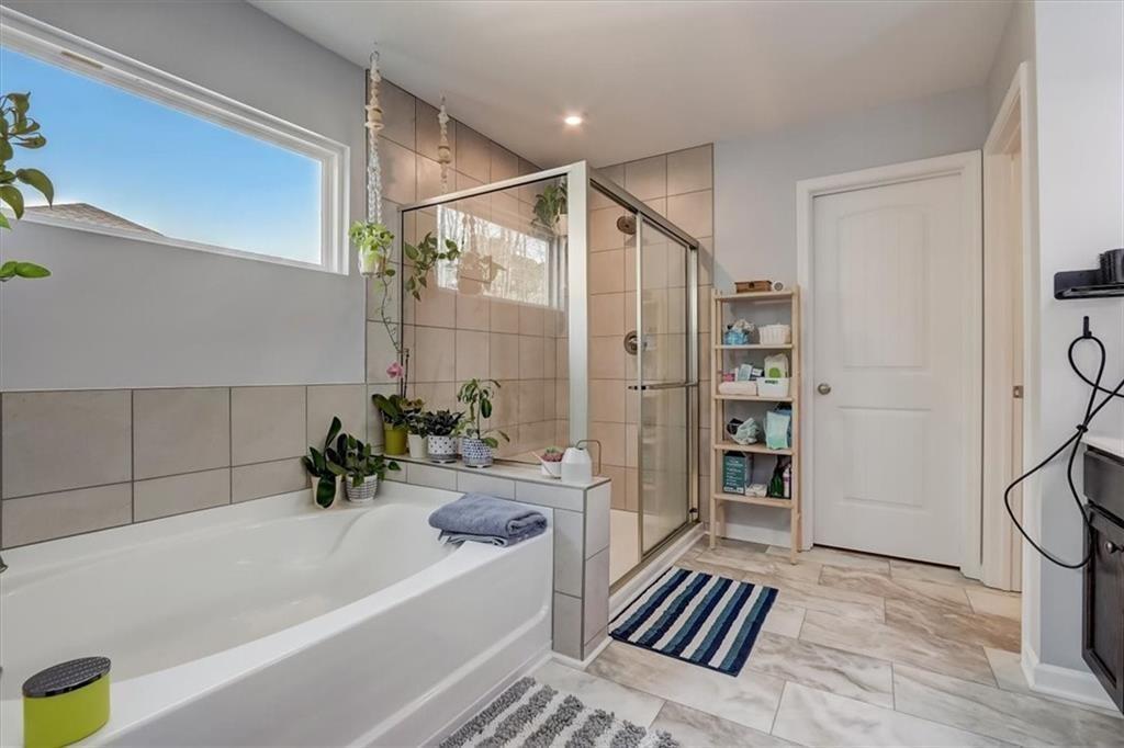 170 Greenbrier Way Canton, GA 30114 - Photo 20 of 34 a bathroom with a bathtub and a shower
