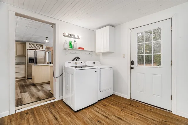 a view of a kitchen with wooden floor and electronic appliances