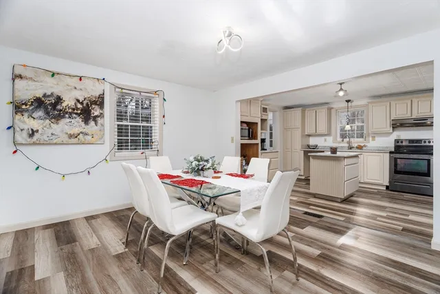 a view of a dining room with furniture and wooden floor