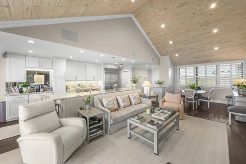 a living room with furniture kitchen and a table