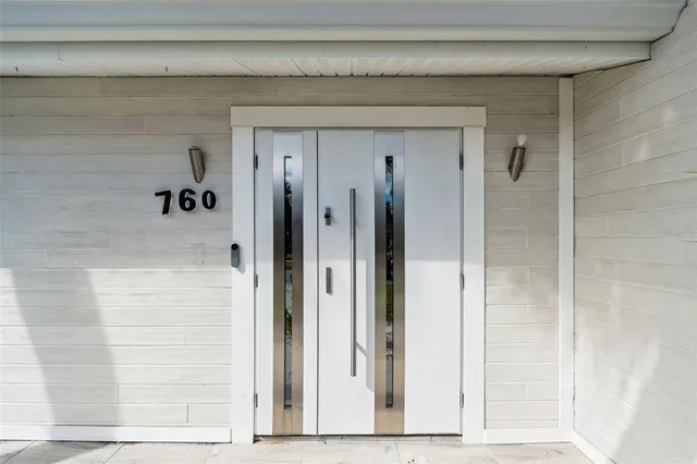 a kitchen with a sink a stove a refrigerator and white cabinets