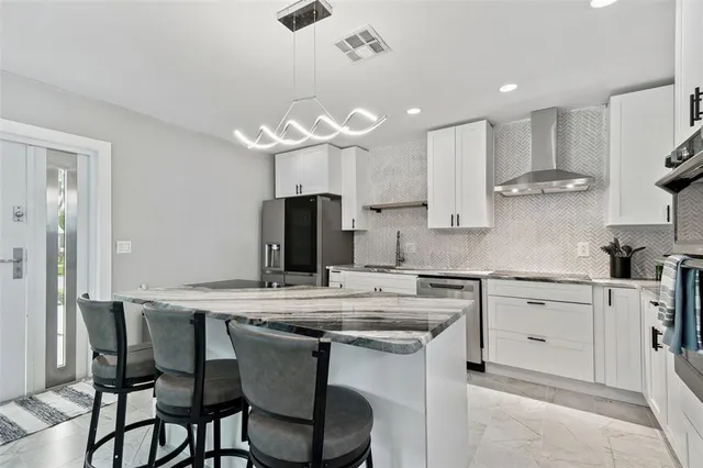 a view of a dining room with furniture large windows and wooden floor