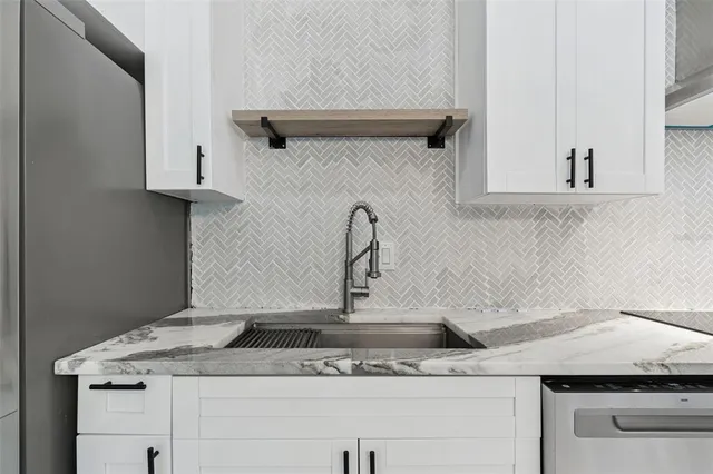 a view of a hallway with closet and bathroom