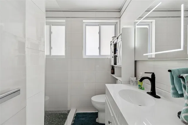 a living room with furniture fireplace and a large window