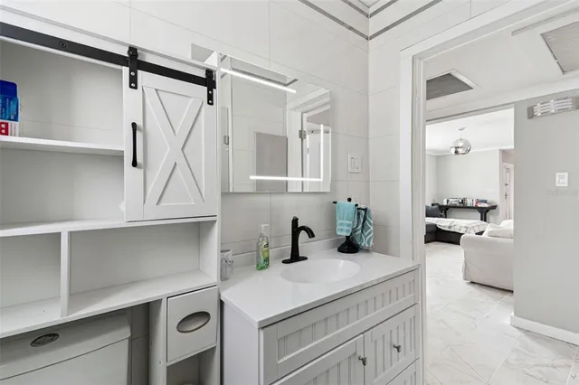 a kitchen with a refrigerator a microwave a sink and a stove