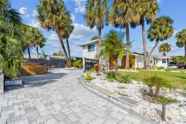 a view of a house with swimming pool and a yard