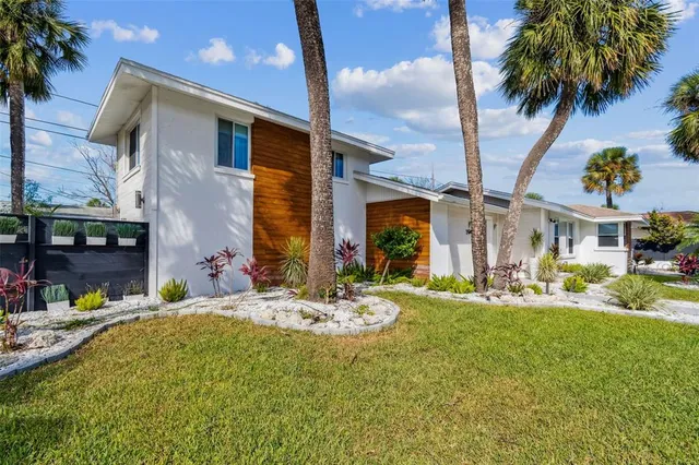 a front view of a house with a glass windows and a table