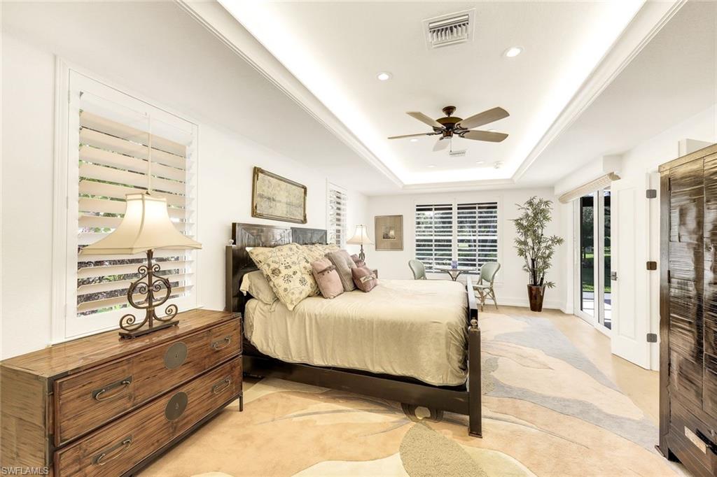 6777 Southern Oak Court Naples, FL 34109 - Photo 16 of 49 Leaving the Primary Bathroom into the tranquil Primary bedroom