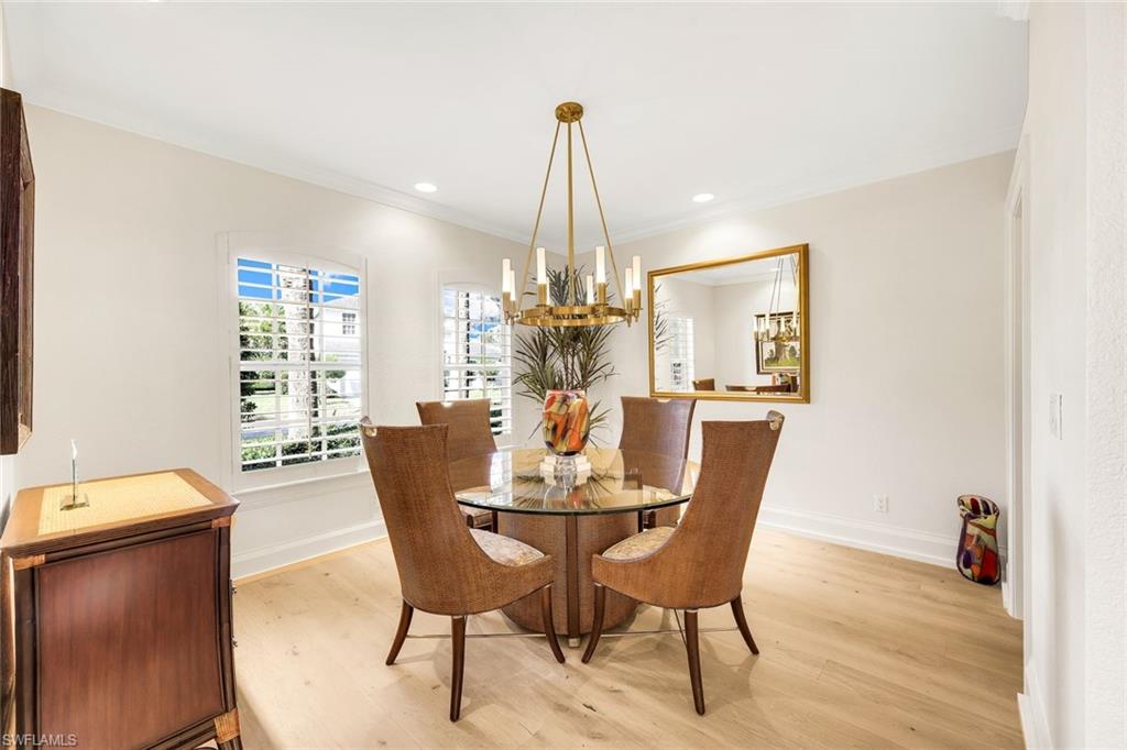 6777 Southern Oak Court Naples, FL 34109 - Photo 19 of 49 Formal Dining Room w/ bespoke Chandelier, recessed lighting, crown molding and plantation shutters