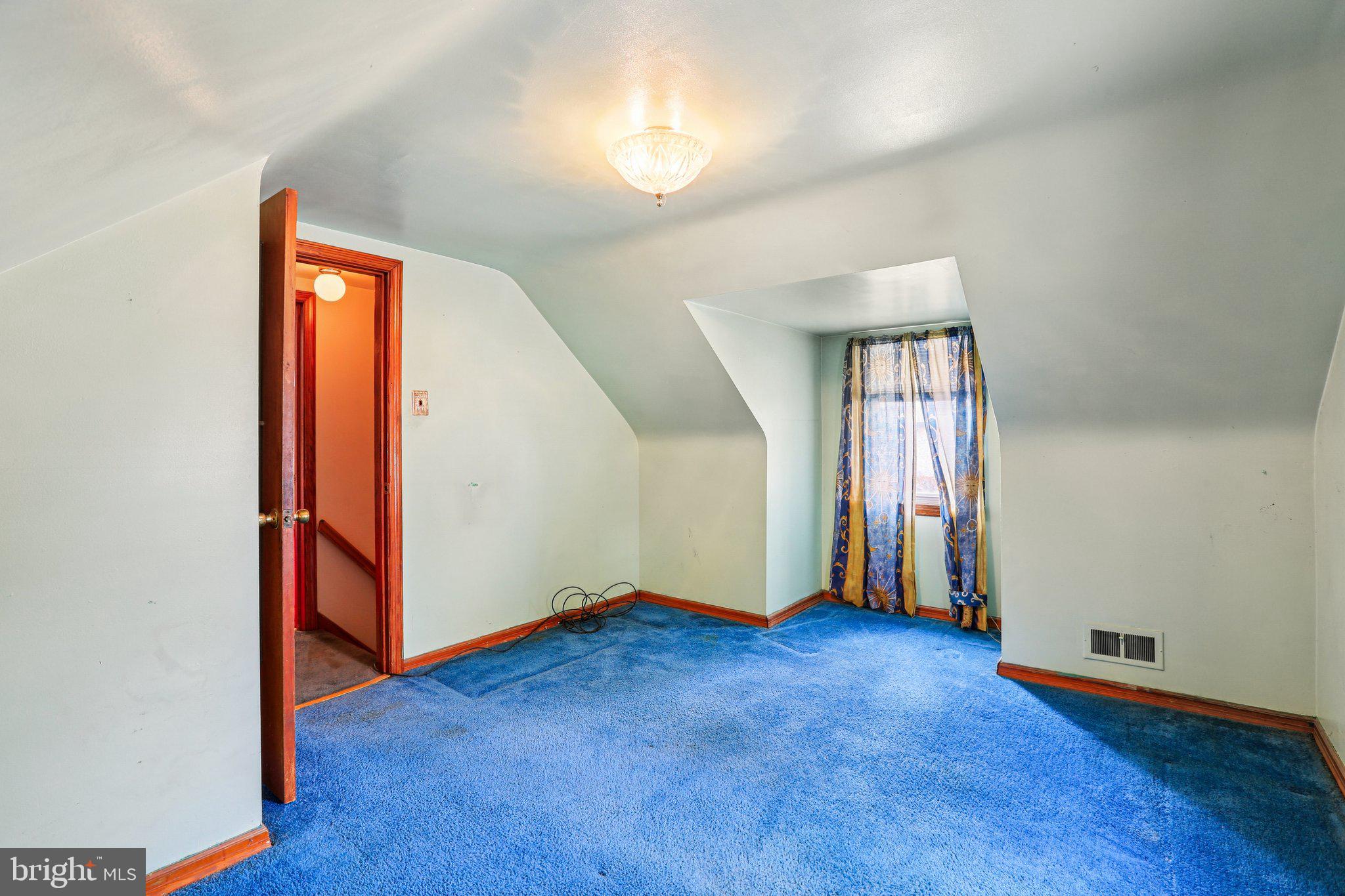 316 Holy Cross Road Brooklyn, MD 21225 - Photo 17 of 32 an empty room with windows and wooden floor