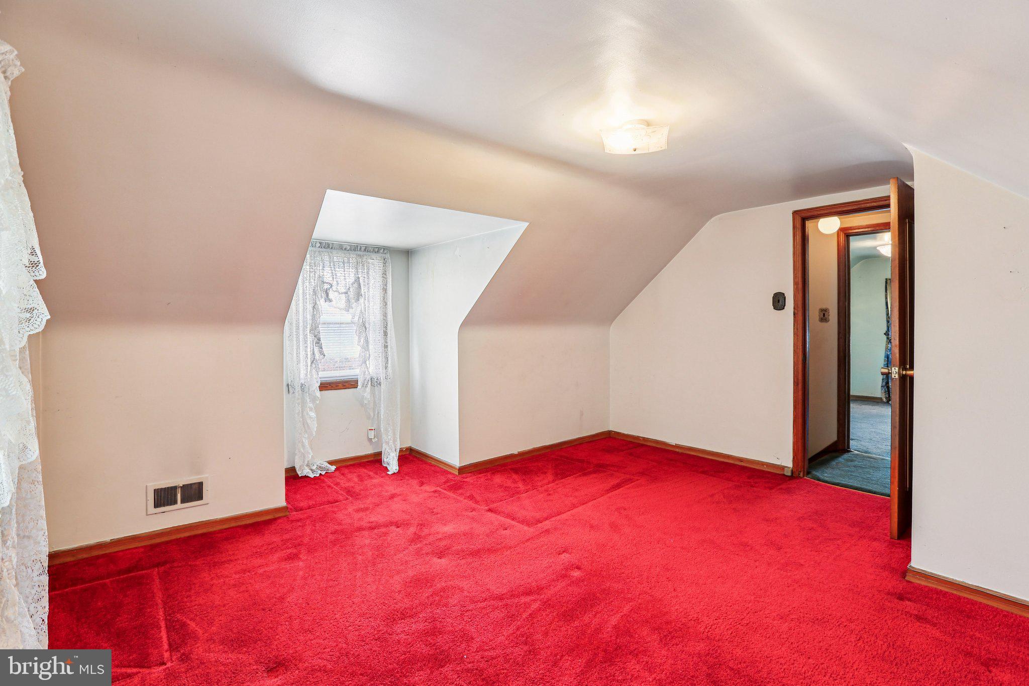 316 Holy Cross Road Brooklyn, MD 21225 - Photo 19 of 32 a bedroom with a bed and a mirror